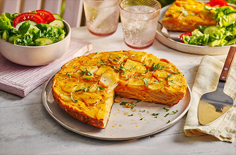 Two classic Spanish dishes collide in this rich and delicious tortilla, served with a crisp salad - the perfect midweek dinner for summer.