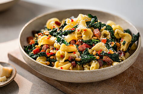 With a gorgeous dark green colour, cavolo nero is a vibrant, nutritious variety of kale brimming with bitter-sweet flavour. We love it paired with punchy pancetta, anchovies, and pine nuts in this simple pasta dinner.
