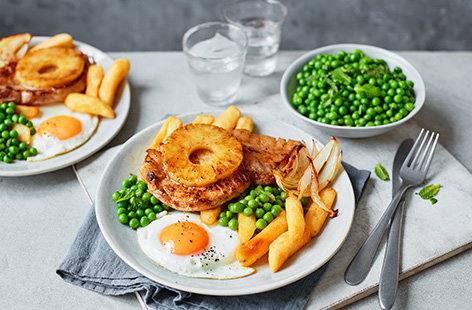 We've updated a pub classic with this pork, egg and chips recipe. Top tender pork loin steaks with juicy caramelised pineapple and a perfectly fried egg, then serve with peas and crispy chips for a simple family favourite.
