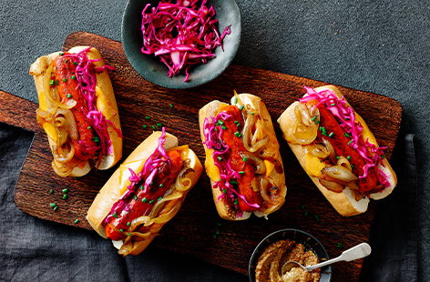 Derek Sarno serves up his plant-based take on hot dogs with beer-braised onions, just in time for Oktoberfest...