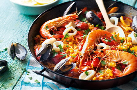 Make your paella punchy with saffron-infused fish stock and carefully placed fresh tiger prawns, mussels and squid