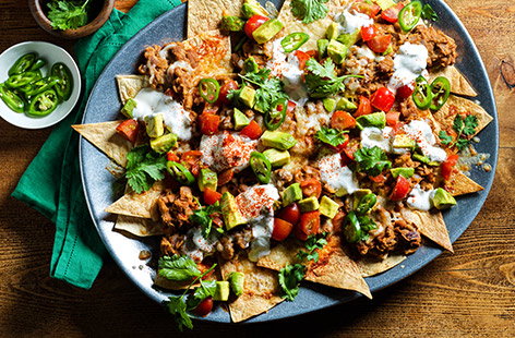 Perfect for sharing, these easy nachos with salsa and refried beans are great for a party or a night in watching a film