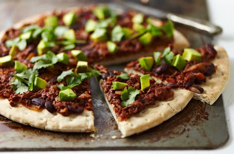 Spice up your pizza topping with this Mexican-influenced chilli pizza with beef mince. Using ready-made pizza bases, it's topped with a rich, tomatoey chilli full of strong, spicy flavours. Garnish with chopped avocado and coriander.