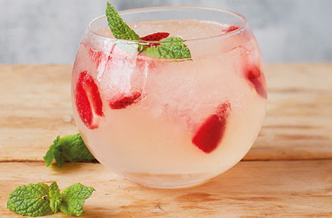 A few fresh strawberries and blush-pink rhubarb syrup elevate this pretty gin and tonic recipe to new summer heights for a refreshing alternative to a classic.