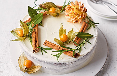 Transform classic Christmas cake into a simple yet stunning centrepiece with beautiful rustic decorations, sweet amaretto-spiced icing, and an almond-encrusted marzipan pinecone