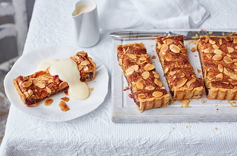 Serve slices of this dairy-free Bakewell tart with a drizzle of creamy almond custard for a scrumptious sweet treat